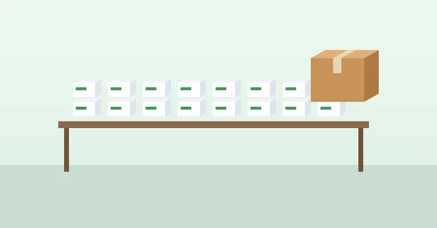 Rows of medicine packs on a table with a carton